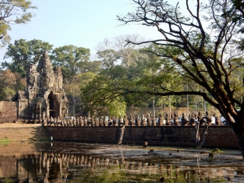 The south entrance to Angkor Thom, 12th century, Siem Reap, Cambodia. Heavy traffic on the bridge