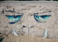 Fanged face. Lost.  Chicago lakefront stone paintings, between Belmont and Diversey Harbors. 2002