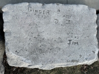Autograph rock: 1933. Ginger, Jim, Don, others, shape with arrow. Chicago lakefront stone carvings, between Belmont and Diversey Harbors. 2024