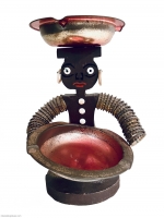 Seated brown bottle-cap figure with painted face and crosspiece on head - vernacular art