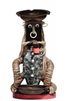Long-haired seated  black bottle-cap figure with glitter and a pipe- vernacular art
