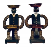 Pair of black seated tallboy bottle-cap figures with painted mouths  - vernacular art