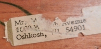 Mailing label on brown bottle-cap figure with carved nose and mouth by the Oshkosh Master - vernacular art