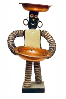 Bottle-cap figure with metal plate on chest, formica plate on back  and notebook reinforcers for eyes and mouth  - vernacular art