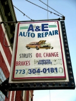 Sign shows mechanic getting a shock. A&E Auto Repair, Pulaski Road near Cornelia, Chicago.-Roadside Art