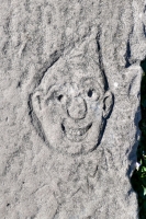 Pointy-topped face, detail. Chicago lakefront stone carvings, between Foster Avenue and Montrose. 2021
