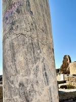 Graffitied pillar with inscription and creature