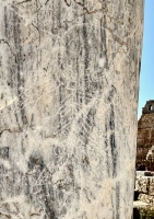 Graffitied pillar with inscription and creature