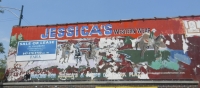 Roadside art: Jessicas Fashion  deteriorated cowboys on wall sign
