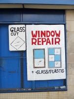 Window repair sign with window drawings
