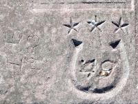 Horseshoe with stars, 49, from 12-panel carving, IG 1983. Chicago Lakefront stone carvings, south of La Rabida Hospital. 2025