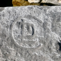 Incomplete peace symbol, CDL (detail), ML, hourglass, NJ Haab. Chicago lakefront stone carvings, south of La Rabida Hospital. 2023