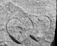 Twin hearts with arrow, detail. Chicago lakefront stone carvings, behind La Rabida Hospital, 65th Street and the Lake. 2018
