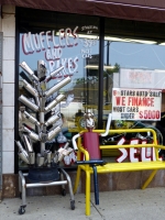 Muffler tree and another muffler man relaxing at 3 Stars Auto Body in July 2014. Lawrence Avenue near Sacramento, Chicago