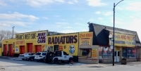 Side and front view of main building with sign and wall paintings. Frank's West Side Auto Parts, Kedzie at 30th Street