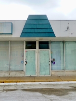 It\'s ideal when a sign\'s mansard roof echoes the prmoted building\'s architecture. Dempster Swift dead strip mall. Skokie, Illinois, 2010