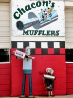 Elaborate muffler people at Chacon's Mufflers, Federal Blvd., Denver, Colorado
