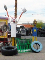Muffler pair at Llantera Tropicana Tires, Las Vegas. As of 2019, Street View showed the blue muffler person still standing, albeit repainted