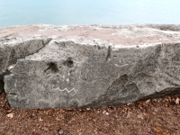 Shapes, smiley face (vertical) on Free Palestine rock. Chicago lakefront stone carvings, Promontory Point. 2025