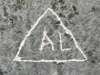 AL, in a triangle. Chicago lakefront stone carvings, Promontory Point. 2025