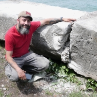 Joel Cardenas with his portrait carving