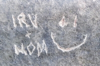 Irv + Mom, smiley face, detail, made during the Oct. 9, 2022, Promontory Point carving workshop. Level 5, vertical. Chicago Lakefront stone carvings, Promontory Point. 2022
