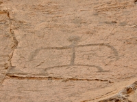 Figure with fingers and a small figure beneath the right shoulder, the Puako petroglyphs