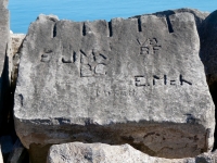 Autograph rock: E, JMK, BC, F, VB, BF, Mitch, E.Mch. Chicago lakefront stone carvings, south of La Rabida Hospital. 2025