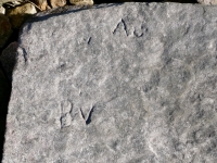 W, A, smiley face, BV. Chicago Lakefront stone carvings, south of La Rabida Hospital. 2025