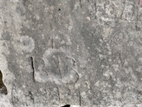 Autograph rock: Karole, Laurie Evett, W, HI, BB (detail), LD, others. Chicago Lakefront stone carvings, south of La Rabida Hospital. 2025