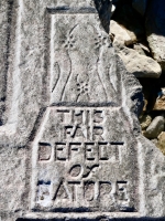 Odd figure, This Fair Defect of Nature, from 12-panel carving. "This fair defect of nature" is from Paradise Lost and refers to the creation of women. Chicago Lakefront stone carvings, south of La Rabida Hospital. 2025