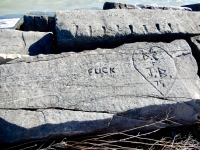 LSD, Fuck, D.C. + J.B. 75, in heart. Chicago lakefront stone carvings, Rainbow Beach. 2019