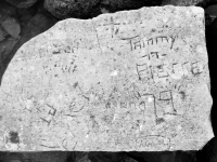 Autograph rock, top: Tammy -n- Pierce "79", PT + OI, Joe, a cross, others. Chicago lakefront stone carvings, Rainbow Beach. 2019