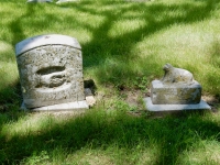 Rosehill tombstone: Clasped hands and reclining anima