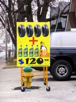 Tires + Oil bottles sign.
