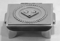 Stanley Szwarc stainless steel face box with small geometric face, front view