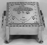 Stanley Szwarc stainless steel face box with dotty hair and earrings, front view