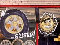 Tire and happy sun window paintings. City Tire, Lincoln near Carmen, Chicago-Roadside Art