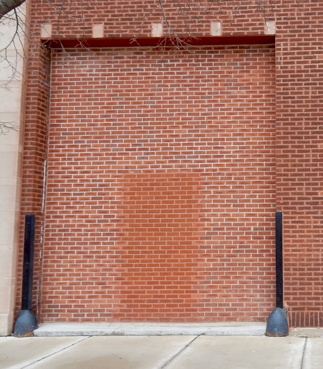 Bricked-in door within a bigger bricked-in door