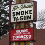 Mike Schrank's Smoke 'N Gun, Washington Street, Waukegon, Illinois. Layers of meaning here and an oddly elaborate sign