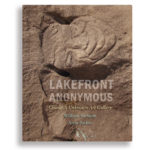 Lakefront Anonymous Book Cover with stone carving of a face